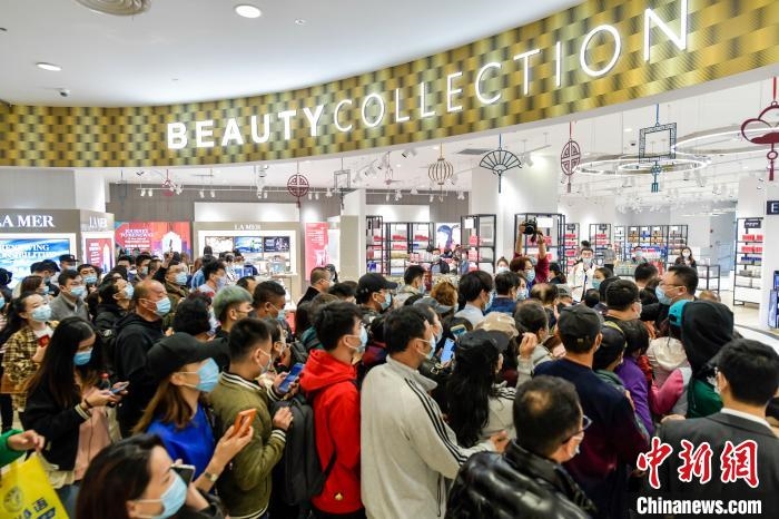 消费者在海控全球精品(海口)免税城一期化妆品区入口等待入场购物 骆云飞 摄