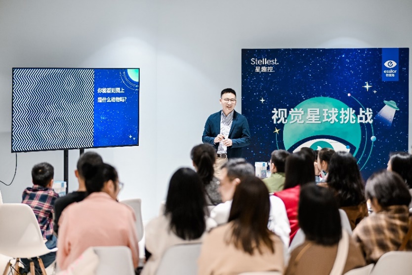A person standing in front of a group of people
Description automatically generated